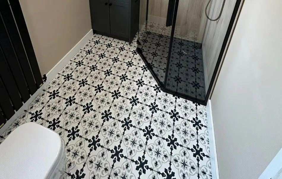 Patterned encaustic style floor tiles laid in a Blackpool shower room